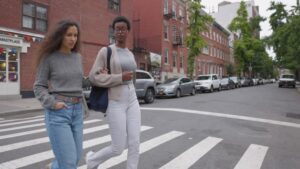 Multi ethnic young students walking in New York City.